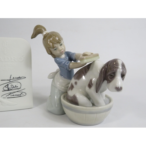 72 - Lladro figurine of a girl bathing a dog, a small dog figurine and a point of sale.