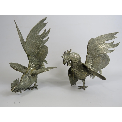 187 - Pair of white metal fighting cockerels, approx 19cm tall.