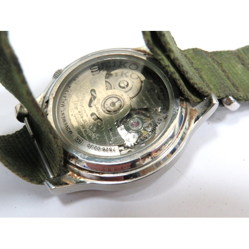 244A - Gents Seiko 21 Jewel Military style automatic watch with clear back to show mechanism. Olive green w... 