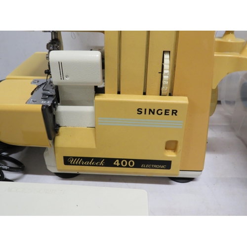 67 - Singer ultralock 400 overlock sewing machine and a selection of cotton reels.