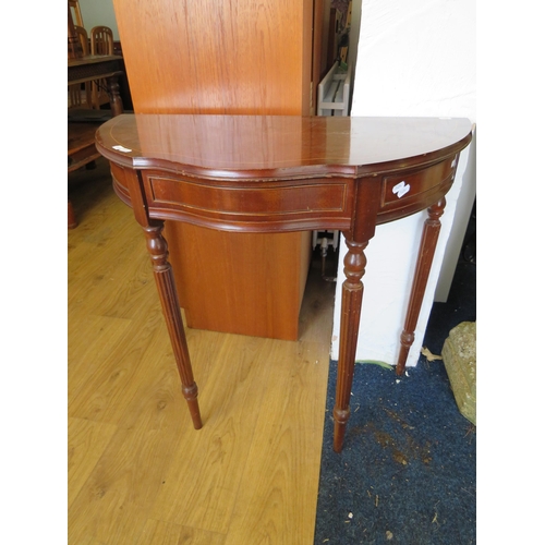 345 - Mahognay Demi lune table raised on reeded legs with handy central drawer. H:30 x W:32 x D:16 inches.... 