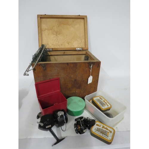 524 - Wooden fishing box seat and a selection of fishing equipment including 2 reels.