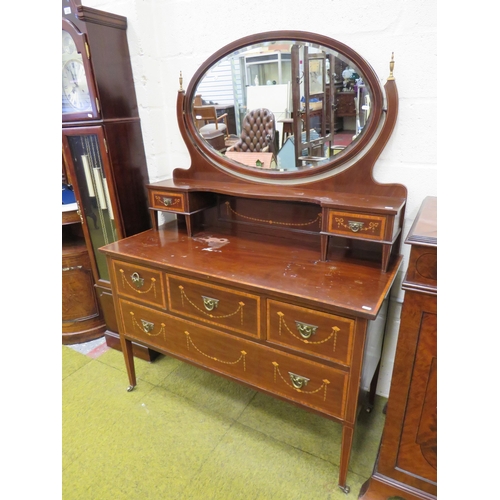 393 - Edwardian Era mirror backed dresser. Raised on tapered legs with original castors.  Inlaid Swags & T... 