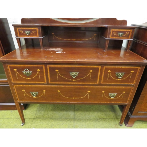 393 - Edwardian Era mirror backed dresser. Raised on tapered legs with original castors.  Inlaid Swags & T... 