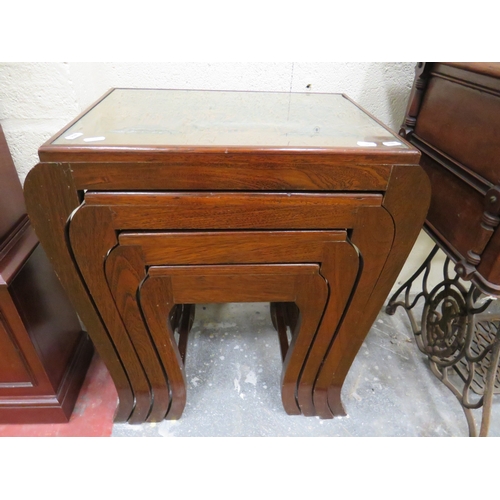 399 - Well Made Oriental set of four stacking tables. Each with lovely carving under glass top. Each in go... 