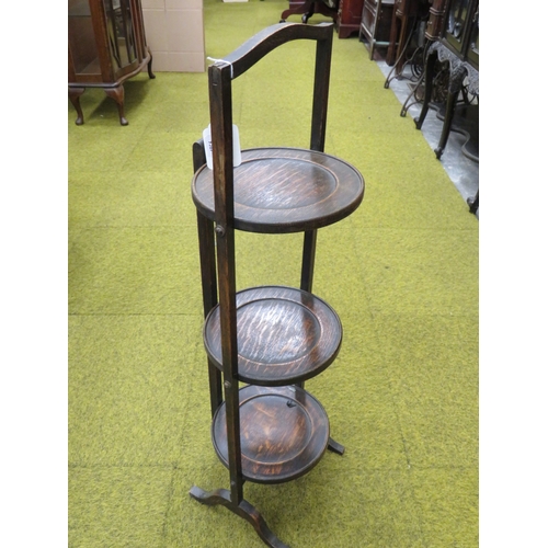 407 - Vintage folding Three tier Oak Cake stand in good order.  Measures approx 34 inches tall.