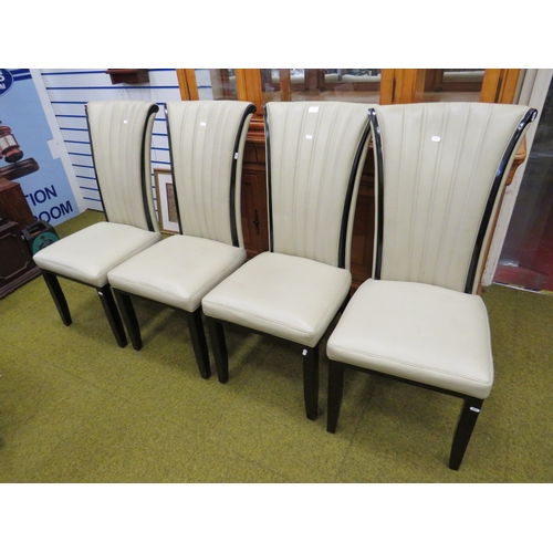 411 - Four Nicely upholstered dining chairs in cream leatherette . Fire tickets present. Seat height 18 in... 