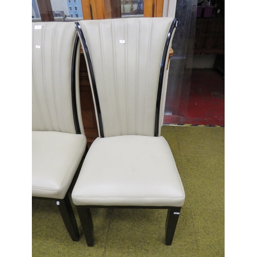 411 - Four Nicely upholstered dining chairs in cream leatherette . Fire tickets present. Seat height 18 in... 