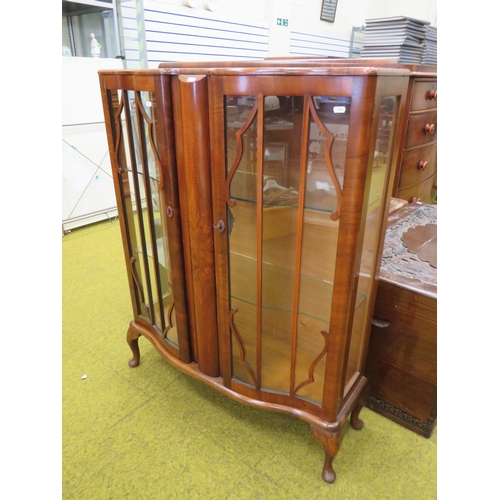 416 - 1930's Era Serpentine fronted Display cabinet with glass shelves inside. Raised on short cabriole le... 