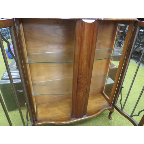 416 - 1930's Era Serpentine fronted Display cabinet with glass shelves inside. Raised on short cabriole le... 