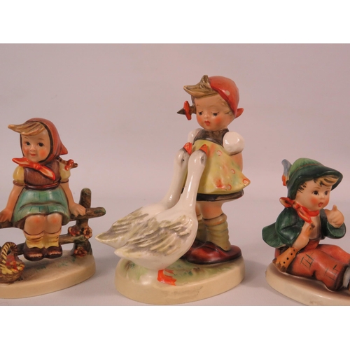 136 - Three Goebel Hummel figurines.