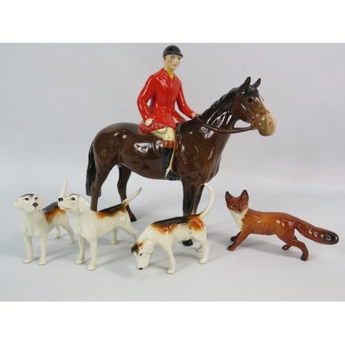 163 - Beswick Huntsman on a bay horse plus three hounds and a fox (one hound has a repair to tail).