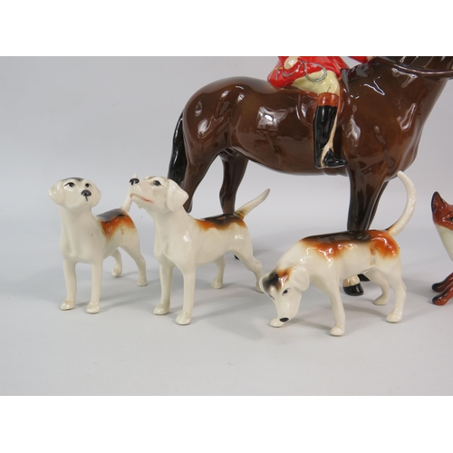 163 - Beswick Huntsman on a bay horse plus three hounds and a fox (one hound has a repair to tail).