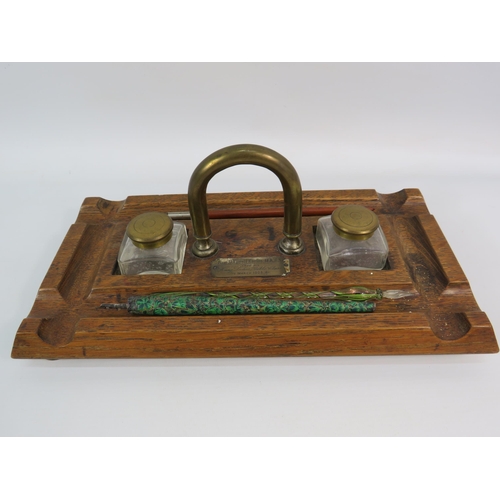 185 - Antique wooden and brass desk tidy with glass ink wells and three antique dip pens. Plaque dated 190... 