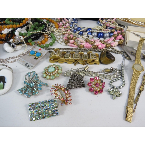 298 - Mixed lot of costume jewellery, watches, brooches, earrings etc.