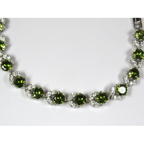 302 - 925 Silver Bracelet set with Emerald Coloured and Clear CZ Gemstones. 7 inches long with one inch de... 