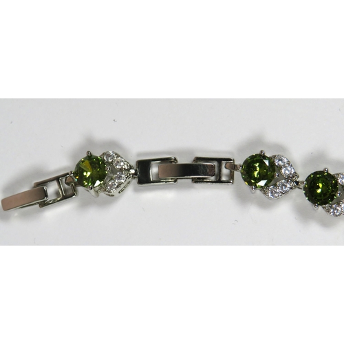 302 - 925 Silver Bracelet set with Emerald Coloured and Clear CZ Gemstones. 7 inches long with one inch de... 