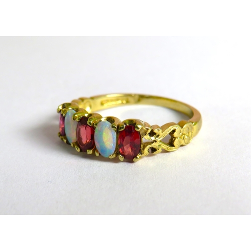 309 - 9ct Yellow gold Ring set with Rubies and Ethiopian Wello Opals which measures approx 6 x 4mm.  Finge... 