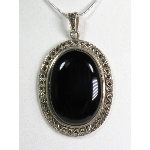 321 - 925 Sterling Silver Marcasite Penant set with a large Onyx stone. Measures approx 60mm x 35mm.