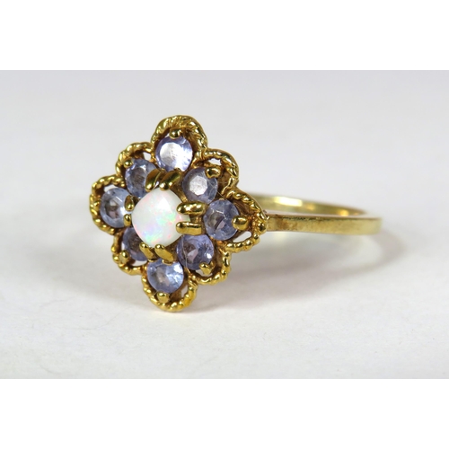 359 - 9ct Yellow Gold ring set with Eight circular Topaz Gemstones with a small white Opal to centre in a ... 