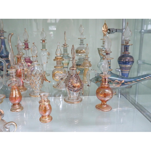 438 - 22 Egyptian glass scent bottles.