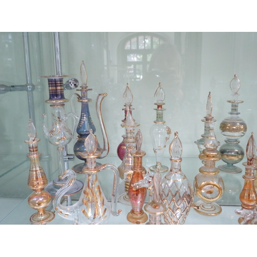 438 - 22 Egyptian glass scent bottles.