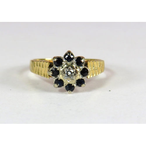 400 - 9ct Yellow Gold Ring set with a Small Central Diamond (3.5mm) surrounded by 8 small 2mm Sapphires. F... 