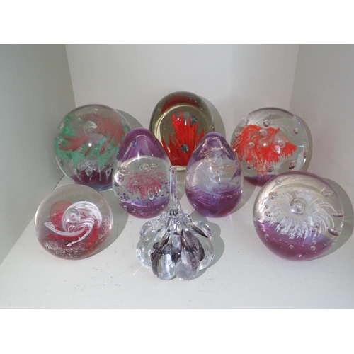 508 - Eight art paperweights, pink, purple and red colours.