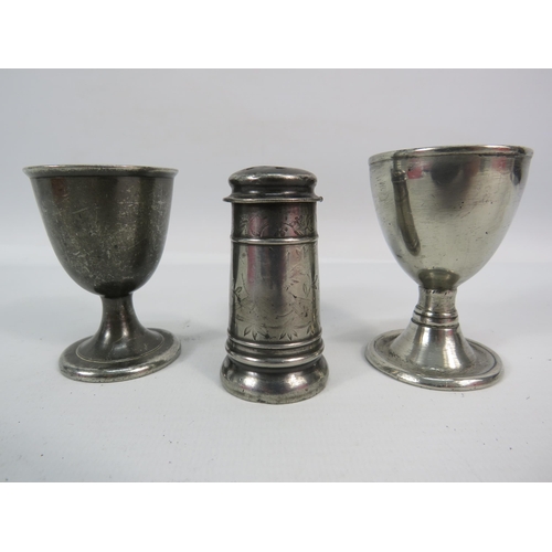 518 - 2 Antique pewter egg cups and a pepper pot.