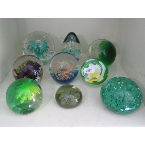 531 - Nine art glass paperweights mainly green colours.