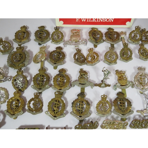 455 - Selection of Military Cap Badges, Mostly RAMC and Royal Signals. Together with a reference book. Bad... 