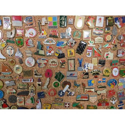 491 - Large Selection of assorted metal and enamel badges. All mounted on a Pine Framed Cork Board display... 