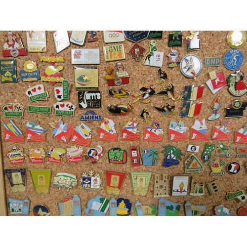 491 - Large Selection of assorted metal and enamel badges. All mounted on a Pine Framed Cork Board display... 