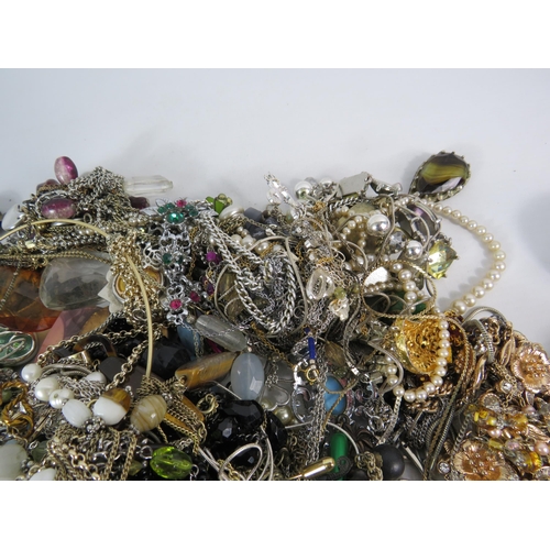 573 - Over 3.5kgs of costume jewellery and a set of cowrie shell napkin rings.