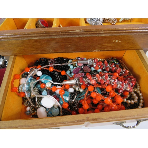 577 - 2 jewellery boxes containing a good selection of costume jewellery and a set of pompador pearls.