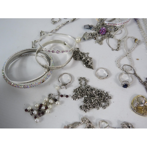 587 - Large selection of 925 silver and silver tone jewellery.