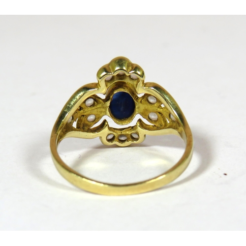 438 - 14ct yellow Gold Ring set with a Central Sapphire (6 x 4 mm) surrounded by 12 Small White Sapphires.... 