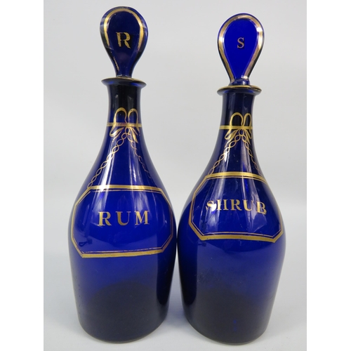 11 - Two antique bristol blue decanters, Rum and Shrub. Approx 9