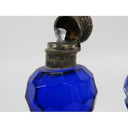 53 - Two antique scent bottles with sterling silver lids, Bristol blue and cut to clear.