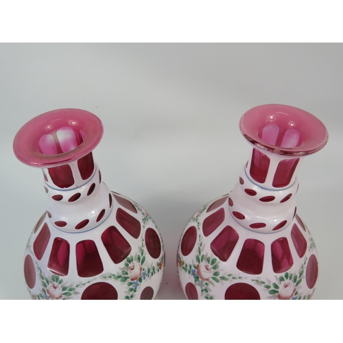 8 - Near Pair of Moser style decanters, white overlay cut to cranberry.