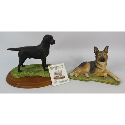 78 - Nature craft Labrador figurine on wooden base plus a German shephard figurine.