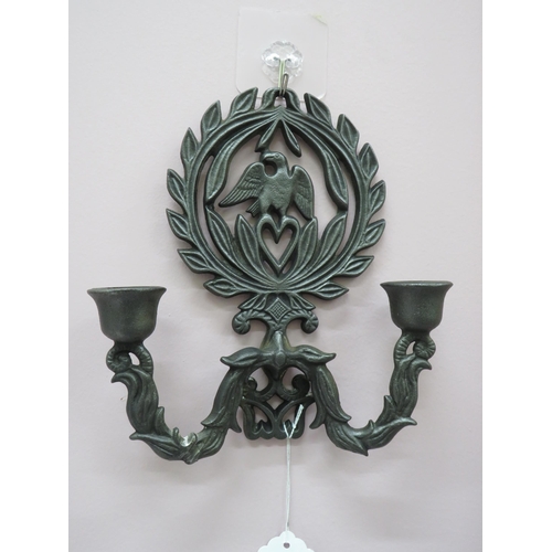 97 - Two cast metal wall sconces decorated with eagles and laurel leaves.