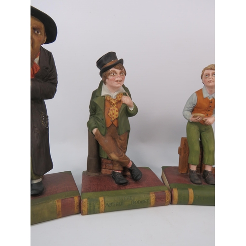 106 - Three Aynsley Oliver Twist figurines and a Mr McCawber, 9.5