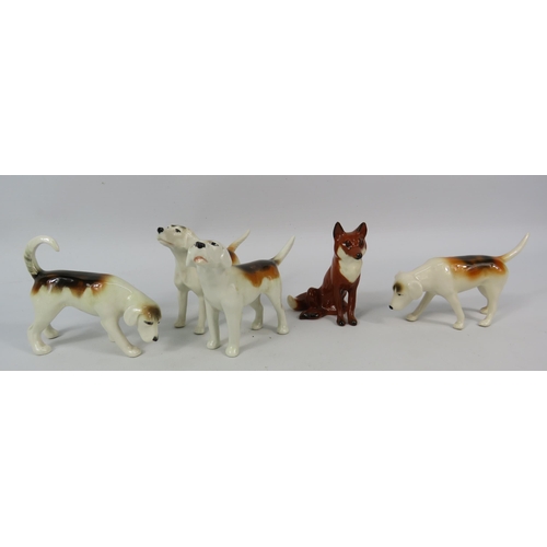 126 - Four Beswick Hounds and a Fox. ( One hound has been repaired).