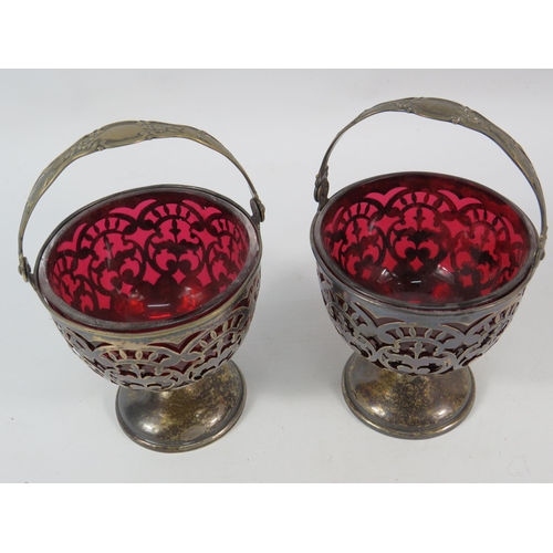 144 - Two Marcus and co pierced sterling silver baskets with cranberry glass liners. Total silver weight 1... 