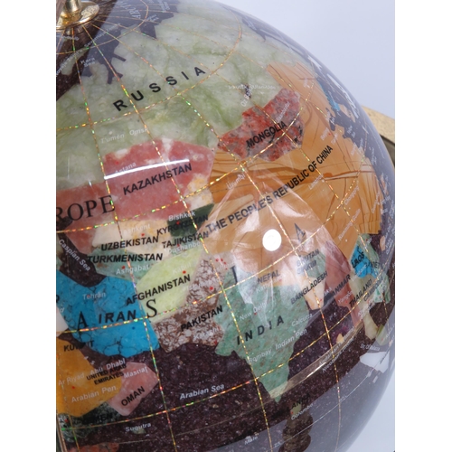 191 - Semi precious stone world globe in a gold could coloured stand (pitting to the gold) 13.5