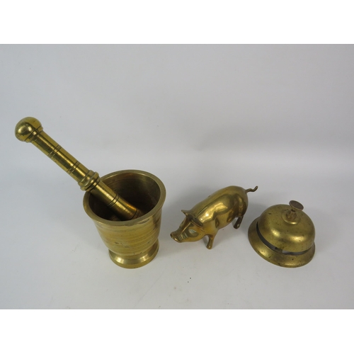 195 - Heavy brass pestle and motar, counter bell and Pig figure.