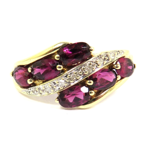 301 - 9ct Yellow Gold Ring set with six Rhodalites with a band of Diamond Chips. Finger size 'Q'  2.4g