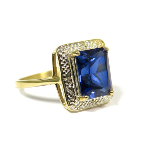 311 - 9ct Yellow Gold Ring set with a Blue Central Sapphire (10 x 8mm) with Diamond Chip Surround.  Finger... 