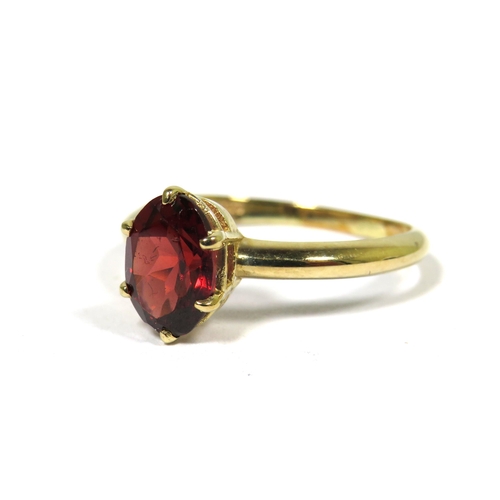 312 - 9ct Yellow Gold Ring set with an Oval Central Garnet (8 x 6mm)  Finger size 'M-5'   1.7g